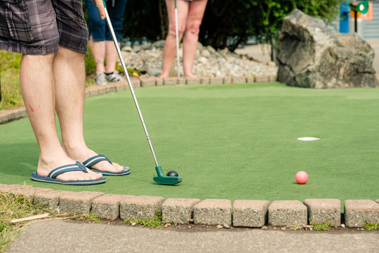 People playing miniature golf