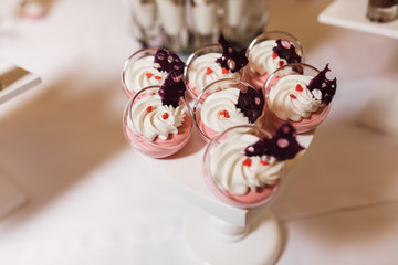 Tasty mousse dessert in a glassware decorated on the white tray