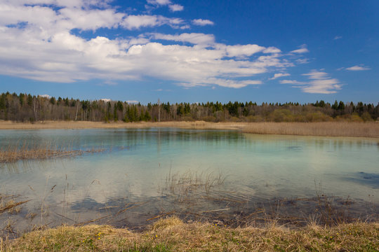 A lake in Russia with very clear azure water. Spring landscape with lake and blue sky. © Анастасия Алексеева