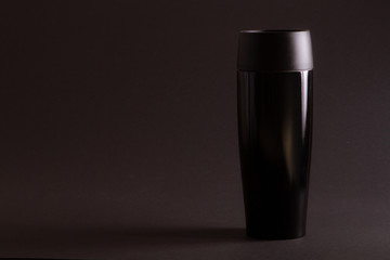 one black thermal bottle shaker for sports nutrition on a black background.
