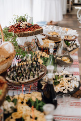 Buffet table with snacks, cheese and other salty delicatessen