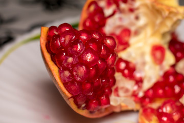 ripe juicy pomegranate with no seeds on the plate