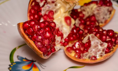 ripe juicy pomegranate with no seeds on the plate