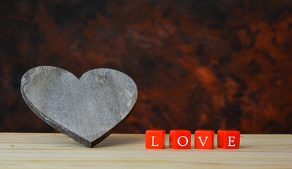 wooden heart and love letters on red dice