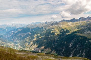 Beautiful high angle view on the Anniviers valley with some picturesque alpine villages seen from top of Sorebois on a cloudy summer day. Zinal, Val d' Anniviers, Switzerland