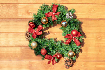 Fototapeta na wymiar Christmas wreath on a wooden background. New year, christmas symbol, holiday concept.