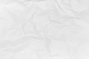 Crumpled paper background of white colour. Creative minimal flat lay. View from above.