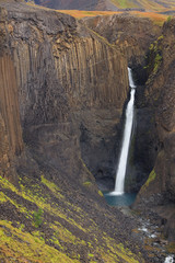 Hengifoss Canyon with the Hengifoss Waterfall, the third highest waterfall in Iceland is surrounded...