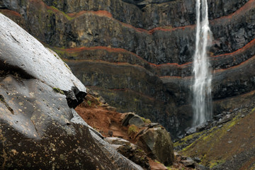 Hengifoss Canyon with the Hengifoss Waterfall, the third highest waterfall in Iceland is surrounded...