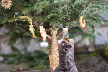 Christmas tree with a bottle of whisky in a shoe
