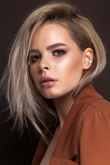Naklejka premium A very beautiful young blonde model with professional make up, perfect skin. Trendy red toned smokey eyes and nude lips.
