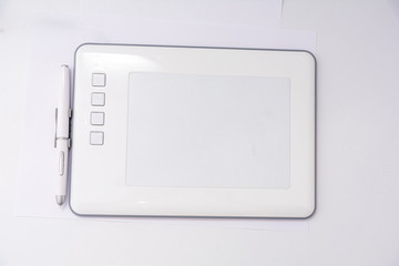 Modern white graphic tablet for drawing with a pen on a white background. Modern white graphic tablet for drawing with a pen.