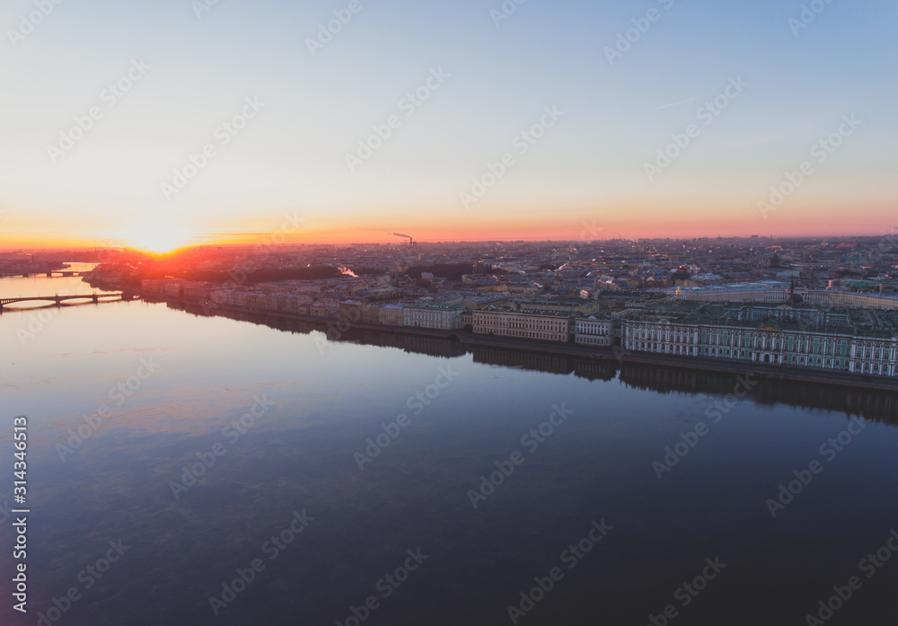 Wall mural Beautiful aerial morning view of Saint-Petersburg, Russia, The Vasilievskiy Island at sunrise, Isaacs Cathedral, Admiralty, Palace Bridge, cityscape and scenery beyond the city, shot from drone