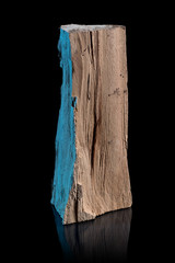 Piece of wood or timber standing isolated on a black shiny surface. Portrait of a wood block