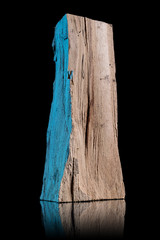 Piece of wood or timber standing isolated on a black shiny surface. Portrait of a wood block