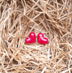 Red hearts on nature paper strip background. Top view, copy space.