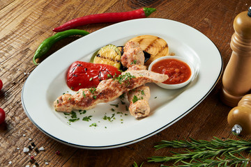 Close up view on grilled Lyulya kebab or Lule kebab. shashlik or barbecue meat. Shish kebab, traditional georgian cuisine food. Copy space for design. Grilled vegetables