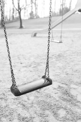 Swing closeup in an empty child playground