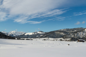 Fototapeta na wymiar winter landscape with a snow-covered house in the ski area reit im winkl