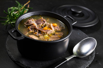 Chicken gizzards stewed with carrot in sauce.