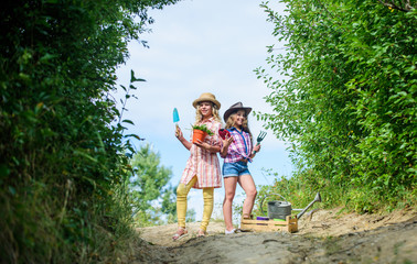 Beauty gardening. ecology and environmental protection. children hold gardening tools. earth day. summer family farm. small girls farmer in village. farming and agriculture. spring country side