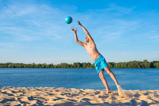 Player in flight with the ball. Sports beach volleyball games. Lifestyle.