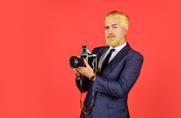 mature man dyed beard and hair. professional photographer make photo. male beauty. capture result of barbershop salon. vintage camera. confident businessman hold retro camera. copy space