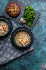 Top view Finnish traditional salmon soup with cream. Kalakeitto. Fish soup with potatoes and carrots. Vertical shot