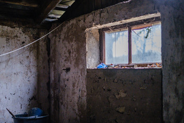 Fototapeta na wymiar old abandoned house interior with broken furniture and empty windows