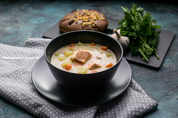 Close up Finnish traditional salmon soup with cream. Kalakeitto. Fish soup with potatoes and carrots.