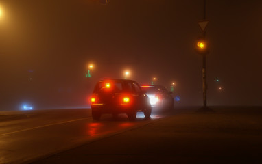 traffic in the city at night and fog