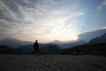 Sunset at Dolomites mountains Italy with person 