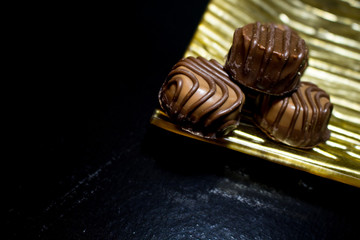 Various of sweet confectionery with chocolate candies and pralines. Handmade chocolates. Realistic chocolate set, delicious dessert pattern.