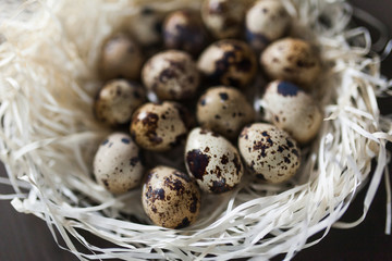 Obraz premium Eggs stacked in a pile or pyramid in a nest on a wooden background . for the Easter holiday . Easter background . new color and light for Easter photos and pictures