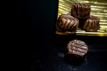Various of sweet confectionery with chocolate candies and pralines. Handmade chocolates. Realistic chocolate set, delicious dessert pattern.