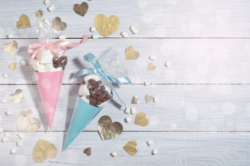 Valentine's Day. Blue and pink presents of candies and marshmallows packed in cones