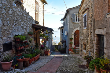 A narrow street between the old houses of a medieval town in Italy