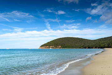 Sea coast in Vada, Tuscany, Italy. Mediterranean nature in summer day, blue, Tyrrhenian sea water on blue sky background. Vacations and nature concept. Copy space.