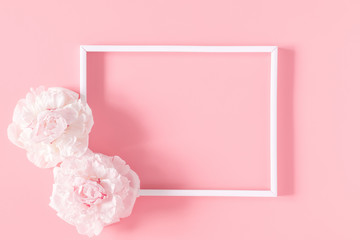 Beautiful flowers composition. Blank frame for text, pink flowers on pastel pink background....