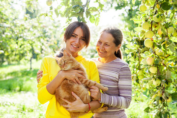 Portrait of   pretty girl next to   mature mother