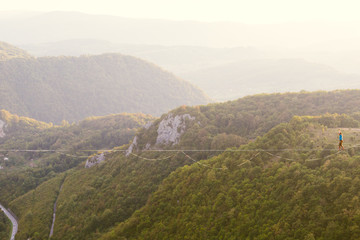 A man walks confidently along the highline.