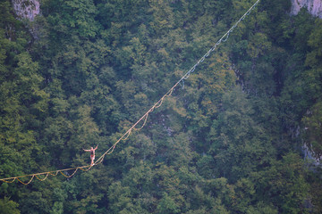 A man walks confidently along the highline.