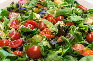 Fresh organic vegetable mixed salad closeup as food background