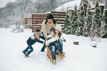 Happy Family sledging outside in winter. Winter time.