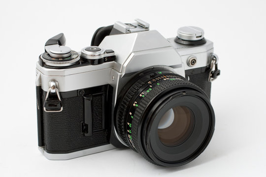 Classic analog single-lens reflex camera isolated on white background