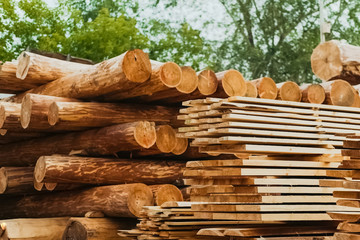 Folded boards and logs on construction site.