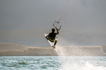Fototapeta na wymiar KiteSurfing in the amazing desert and ocean of Peru.
