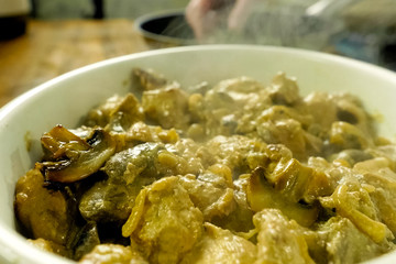 Fried pieces of chicken with mushrooms, in milk in a cup