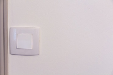 White switch made in plastic in a wall