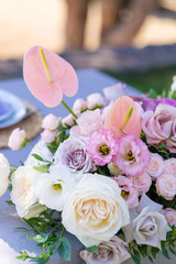 Bouquets of fresh flowers decoration of the festive table. Celebrating an open air party. Decor Details